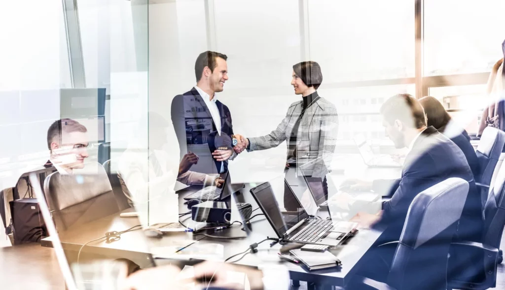 confident business people shaking hands moder corporate office - VIRTUO SOC